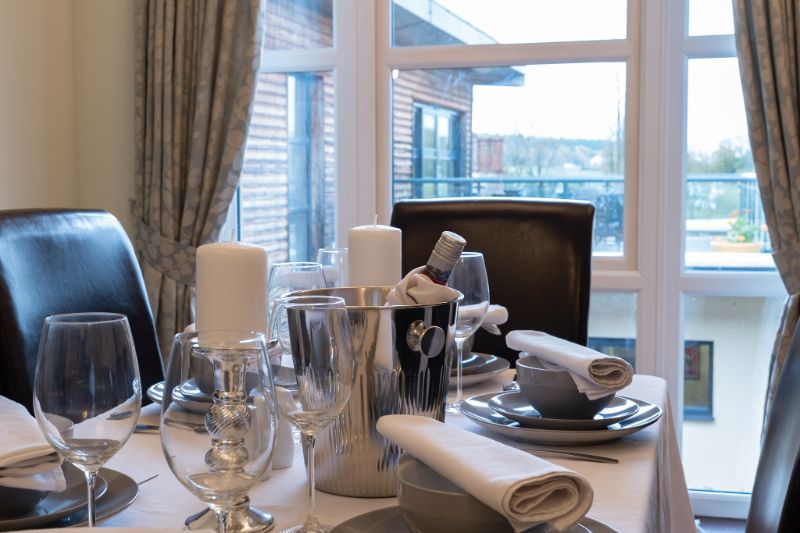 one of our dining tables setup with cutlery and plates