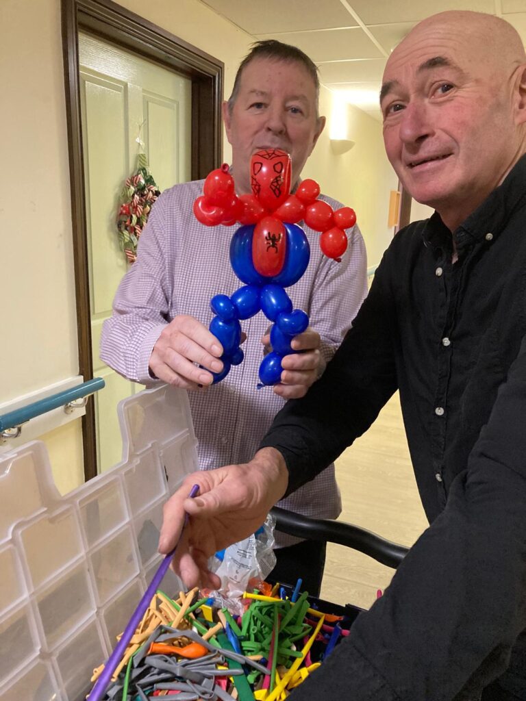 a balloon modeller with one of our residents