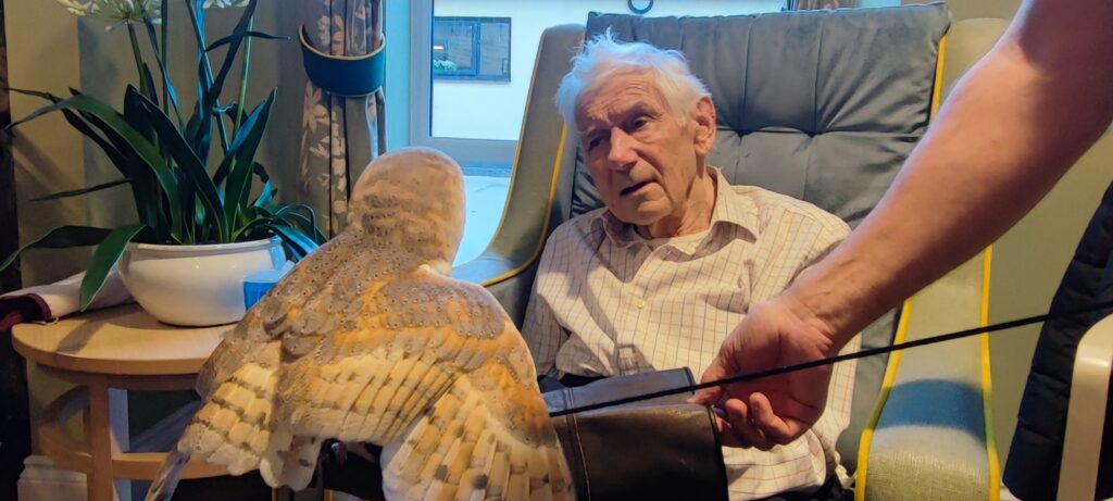 male resident holding a barn owl