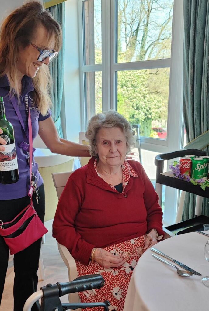 resident having wine poured for her