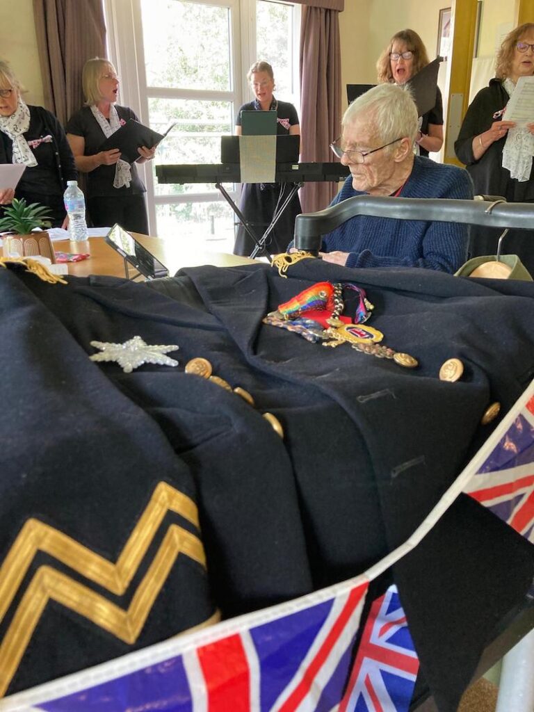 VE uniforms on display whilst the choir sings to residents