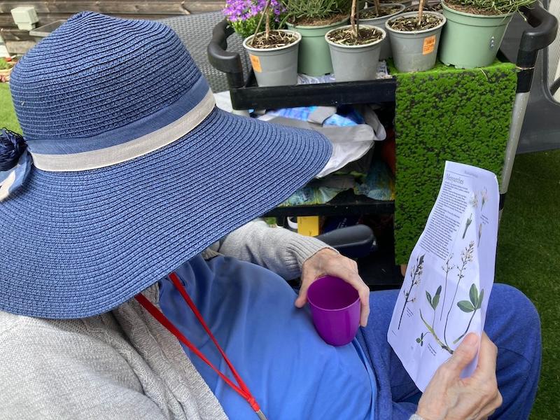 one of our residents looking at an information sheet