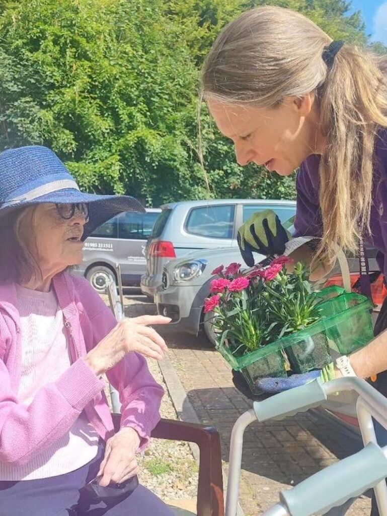 one of our residents looking at flowers bought at the garden centre