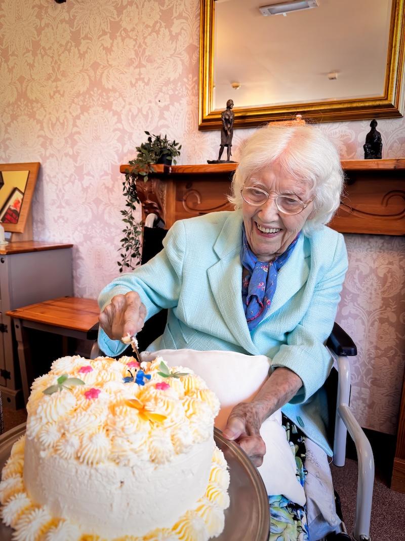 one of our female residents cutting her birthday cake