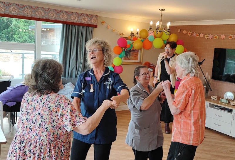 residents dancing together in the lounge
