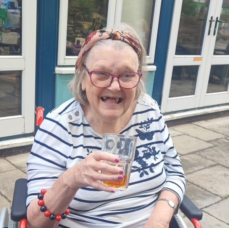 resident sat at a table enjoying a drink