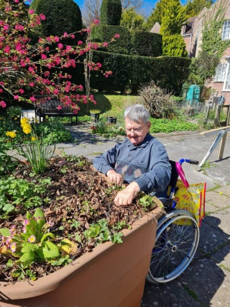 resident looking in raised planter