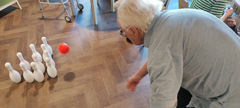 one of our residents playing indoor bowling