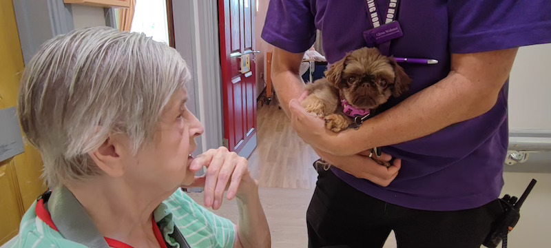 resident sat down with therapy dog