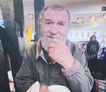 older man sat with coffee