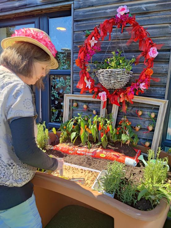 a resident standing at a planter