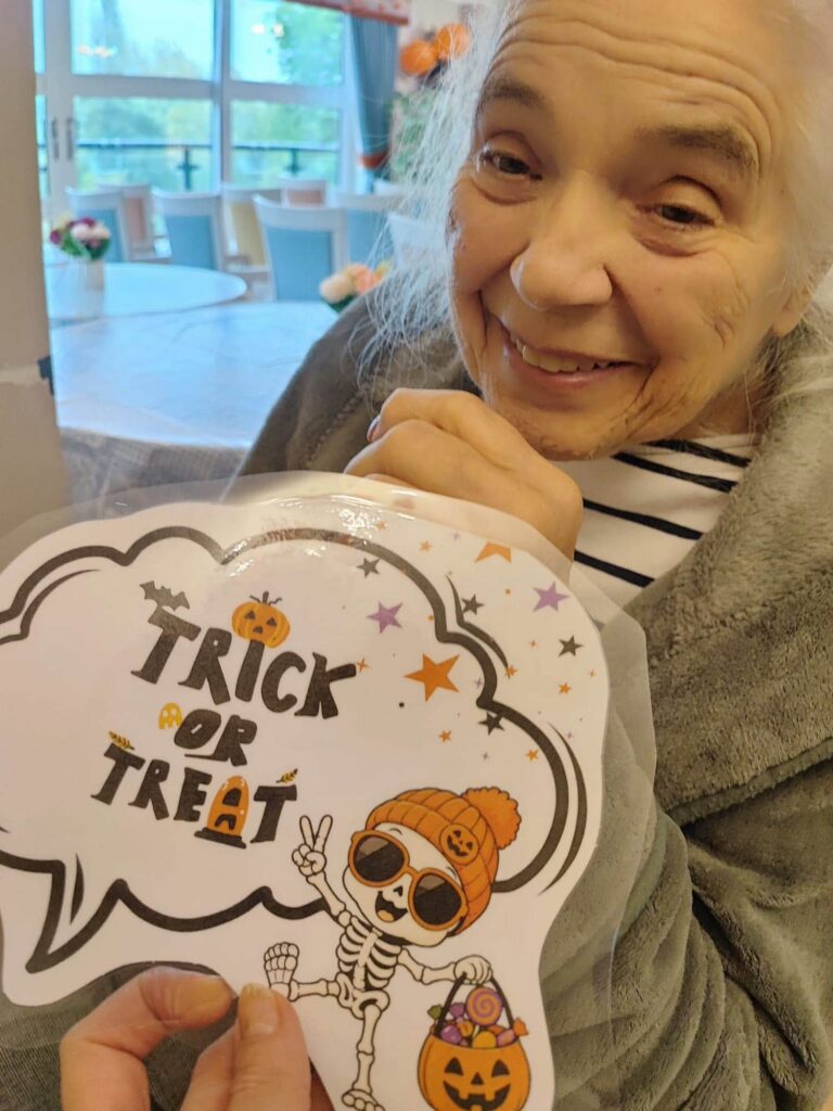a lady with a trick or treat sign